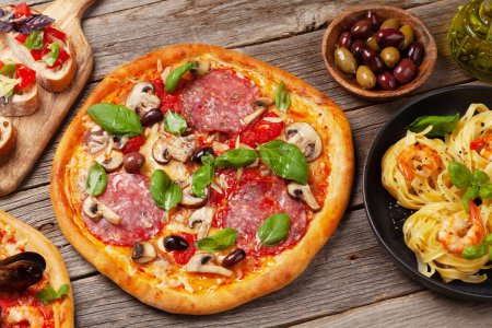 Photo for Italian cuisine. Pasta, pizza, olives and antipasto toasts - Royalty Free Image