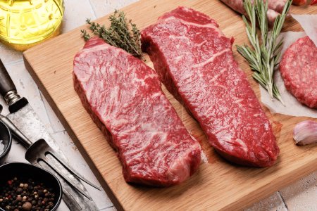 Prime marbled beef steaks and spices. Raw striploin steak