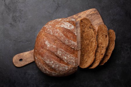 Photo for Sliced homemade bread on cutting board. Flat lay with copy space - Royalty Free Image