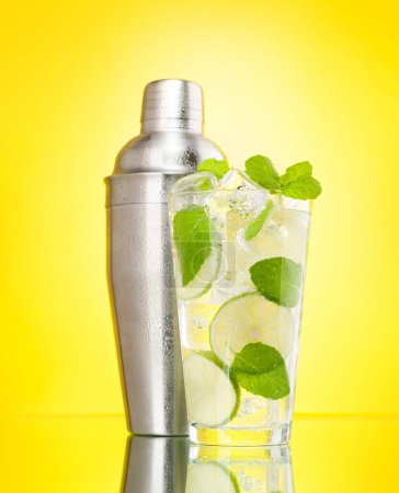 Photo for Mojito cocktail and cocktail shaker on yellow background - Royalty Free Image