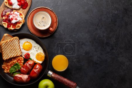 Photo for English breakfast with fried eggs, beans, bacon and sausages. Coffee and orange juice. Top view flat lay with copy space - Royalty Free Image