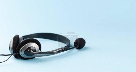 Photo for Headset on blue background with copy space. Template for service or support - Royalty Free Image