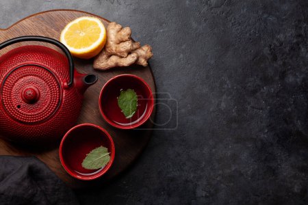 Photo for Tea with lemon and mint and teapot on wooden board. Top view flat lay with copy space - Royalty Free Image