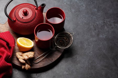 Photo for Tea with lemon and mint and teapot on wooden board. With copy space - Royalty Free Image