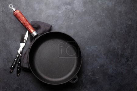 Photo for Empty frying pan, fork and knife. Top view flat lay with copy space - Royalty Free Image