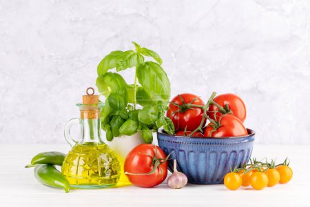 Téléchargez les photos : Ingrédients pour la cuisine. Cuisine italienne. Tomates, huile d'olive, basilic. Avec espace de copie - en image libre de droit