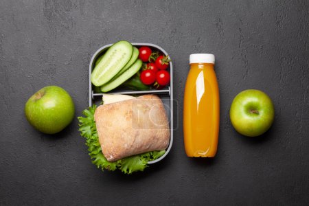 Photo for Lunch box with sandwich, vegetables and juice. School or office meal. Flat lay - Royalty Free Image