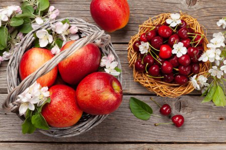 Foto de Manzanas rojas maduras y cereza sobre mesa de madera. Vista superior plano laico - Imagen libre de derechos