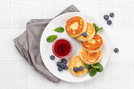 Photo for Cottage pancakes with berry jam and berries. Top view flat lay - Royalty Free Image