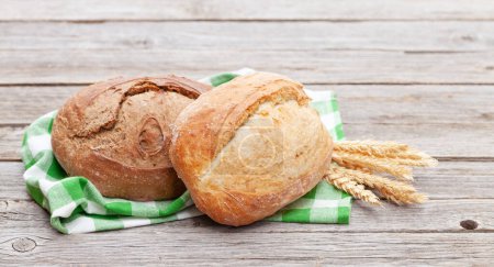 Photo for Homemade bread on wooden table. Outdoor - Royalty Free Image