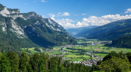 Photo for Panoramic view of countryside, green alpine meadows and the Alps mountains in Switzerland - Royalty Free Image