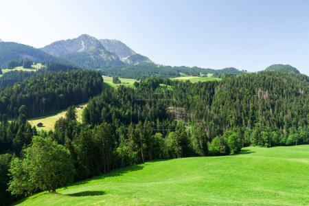 Photo for Panoramic view of green alpine meadows and the Alps mountains in Switzerland - Royalty Free Image
