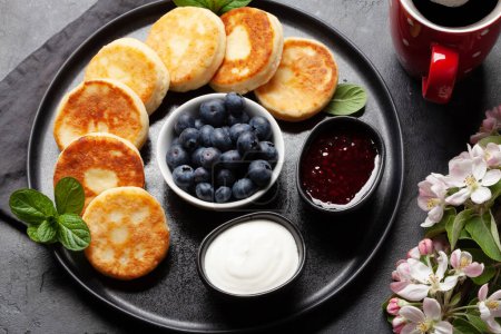 Photo for Cottage pancakes with berry jam, sour cream and berries - Royalty Free Image