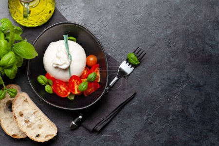 Photo for Burrata cheese, various tomatoes and olives. Italian cuisine. Flat lay with copy space - Royalty Free Image