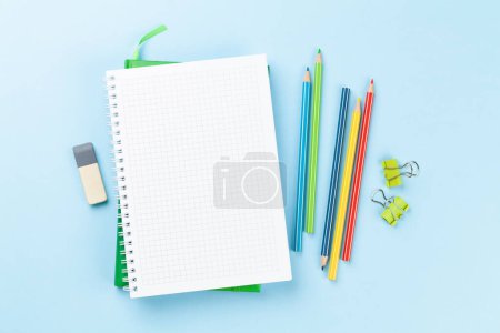 Photo for Blank notepad and colorful pencils. Flat lay over blue background with copy space - Royalty Free Image