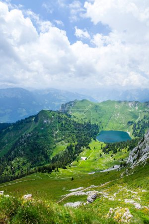 Photo for Panoramic view of lake, green alpine meadows and the Alps mountains in Switzerland - Royalty Free Image