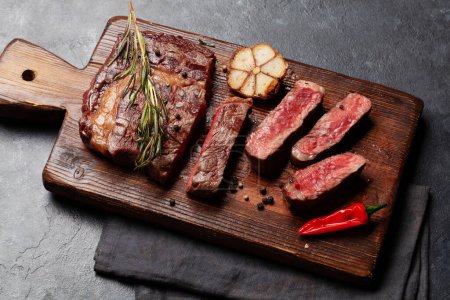 Photo for Grilled ribeye beef steak with herbs and spices - Royalty Free Image