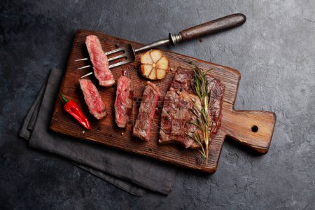 Photo for Grilled ribeye beef steak with herbs and spices. Flat lay - Royalty Free Image