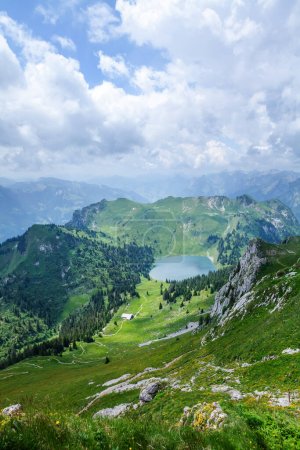 Photo for Panoramic view of lake, green alpine meadows and the Alps mountains in Switzerland - Royalty Free Image