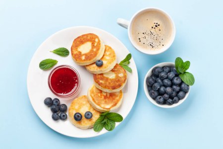 Photo for Cottage pancakes with berry jam and berries. Breakfast with coffee. Top view flat lay - Royalty Free Image