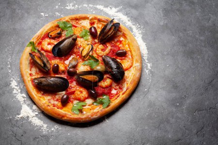 Photo for Italian cuisine. Seafood pizza. On stone table with copy space - Royalty Free Image