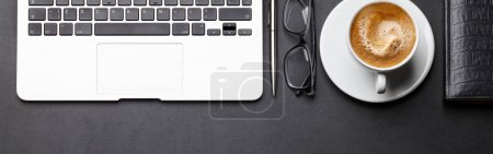 Photo for Office workplace table with coffee cup, supplies and laptop. Flat lay with space for your goals - Royalty Free Image