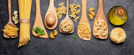Photo for Various pasta in wooden spoons. Top view flat lay - Royalty Free Image
