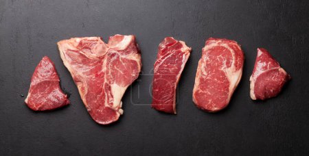 Photo for Various raw beef steaks. Top view flat lay - Royalty Free Image