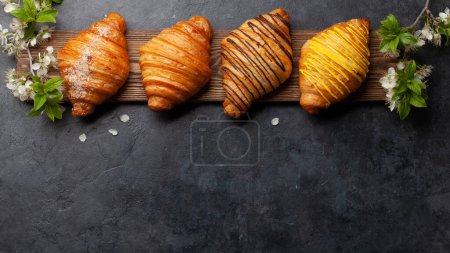 Photo for Various croissants on wooden board. French breakfast. Top view flat lay with copy space - Royalty Free Image