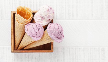 Photo for Berry ice cream sundae in waffle cones. Flat lay with copy space - Royalty Free Image