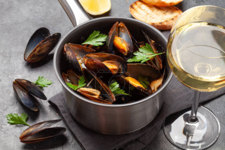 Photo for Traditional seafood mussels with baguette toasts and white wine - Royalty Free Image