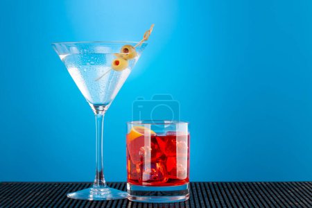 Photo for Martini and negroni cocktail on blue background with copy space - Royalty Free Image