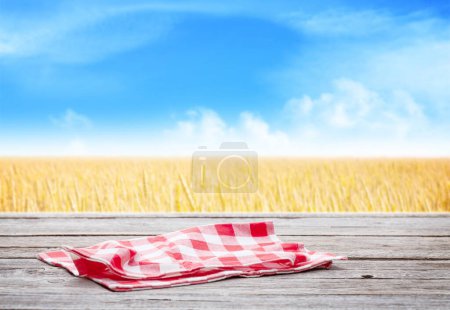Photo for Wooden table with tablecloth and copy space for your product - Royalty Free Image
