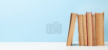 Photo for Old books on wooden table and copy space. School and education template - Royalty Free Image