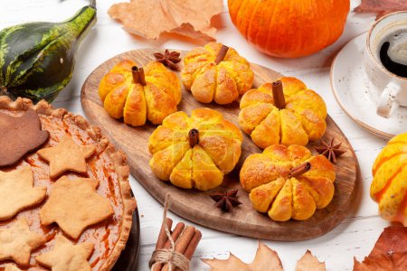 Photo for Homemade pumpkin look muffins and various pumpkins - Royalty Free Image