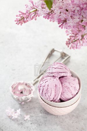 Téléchargez les photos : Crème glacée aux baies sundae et fleurs lilas. Avec espace de copie - en image libre de droit
