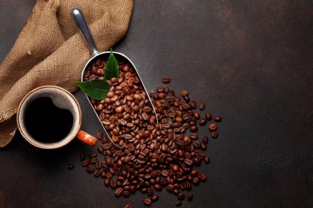 Photo for Roasted coffee beans in scoop and cup of espresso. Flat lay on stone table with copy space - Royalty Free Image