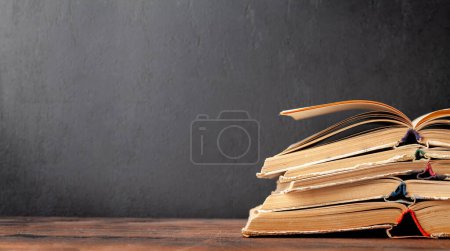 Photo for Old books on wooden table and blackboard for copy space. School and education template - Royalty Free Image