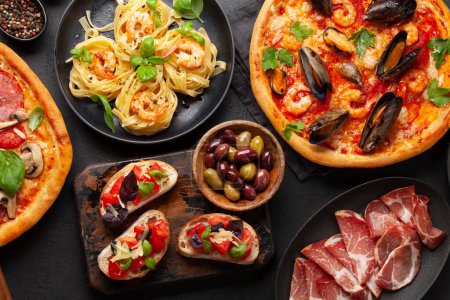 Photo for Italian cuisine. Pasta, pizza, olives and antipasto toasts. Flat lay - Royalty Free Image
