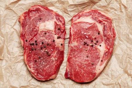 Photo for Two raw ribeye beef steaks. Top view flat lay - Royalty Free Image
