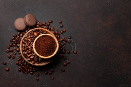 Photo for Ground coffee, roasted coffee beans and macaroons. Top view flat lay with copy space - Royalty Free Image