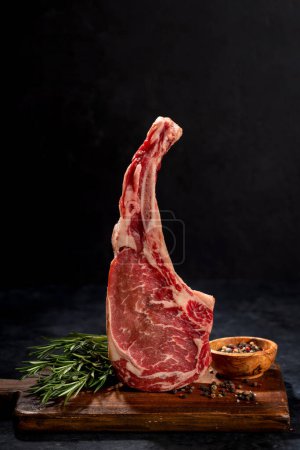 Photo for Raw Tomahawk beef steak and spices. Ready for grilling - Royalty Free Image