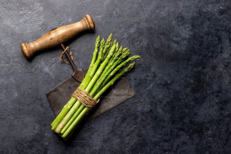 Photo for Bunch of fresh asparagus on stone table. Flat lay with copy space - Royalty Free Image