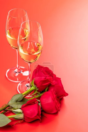 Photo for Valentines day card with champagne and rose flowers. On red background with space for your greetings - Royalty Free Image