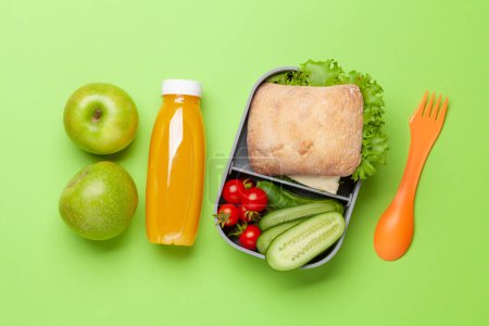 Photo for Lunch box with sandwich, vegetables and juice. School or office meal. Flat lay - Royalty Free Image