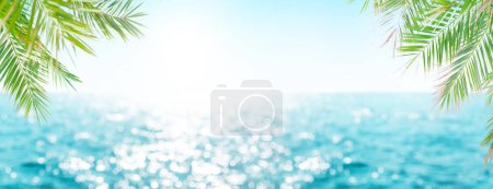 Photo for Defocused blue sea landscape background with sunny bokeh and palm leaves - Royalty Free Image