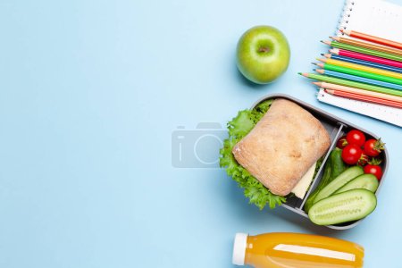 Photo for Lunch box with sandwich, vegetables and juice. School or office meal. Flat lay with copy space - Royalty Free Image