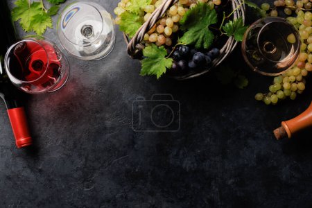Photo for White, rose and red wine glasses, bottles and grape in basket. Flat lay with copy space - Royalty Free Image