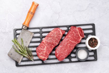 Photo for Prime marbled beef steaks and spices. Raw striploin steak. Flat lay with copy space - Royalty Free Image