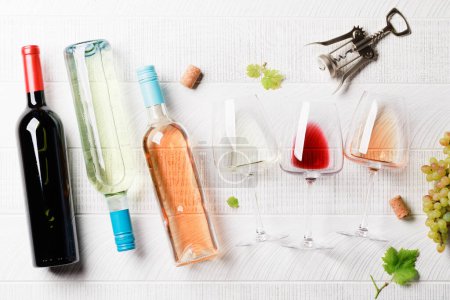 Photo for White, rose and red wine bottles and glasses. Flat lay - Royalty Free Image